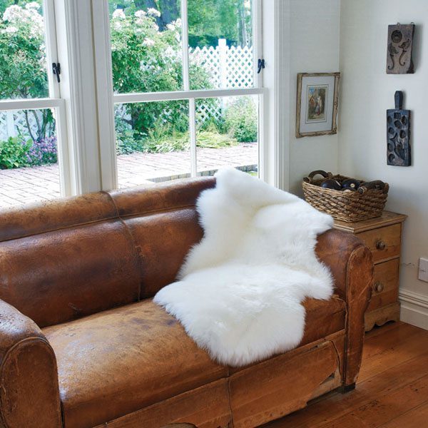 single white sheepskin on couch